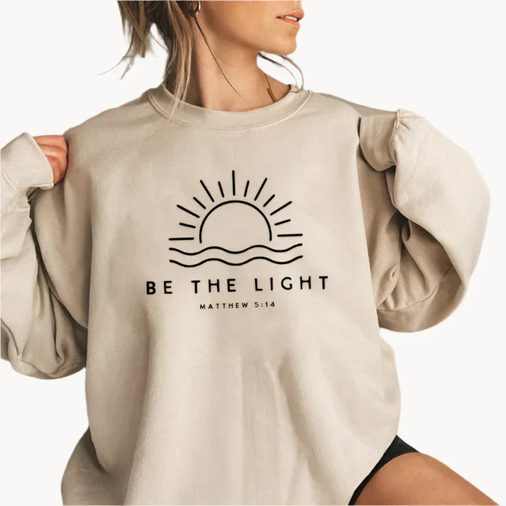 Jumper med modern be the light textlogotyp på framsidan för kvinnor